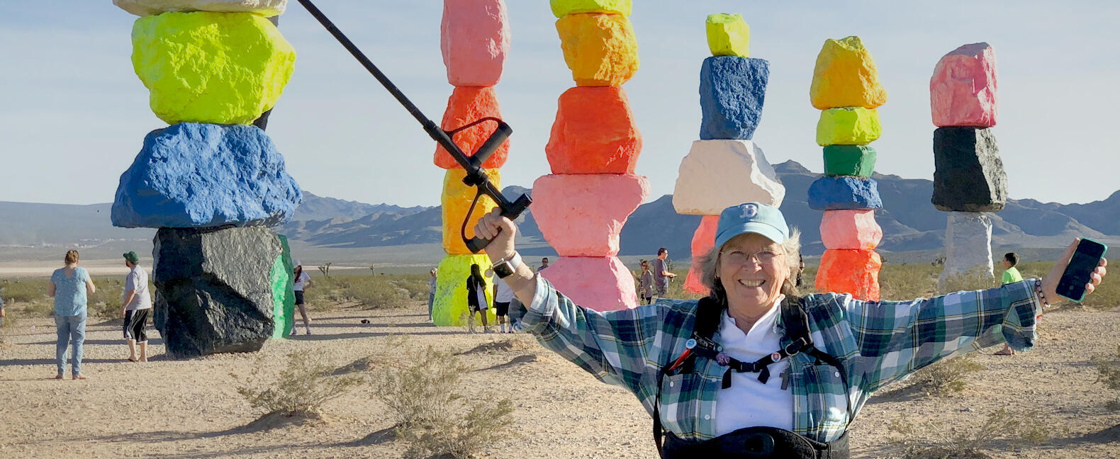 Still of Una posing in front of colorful stacked rocks in &quot;Sister Una Lived a Good Death&quot;